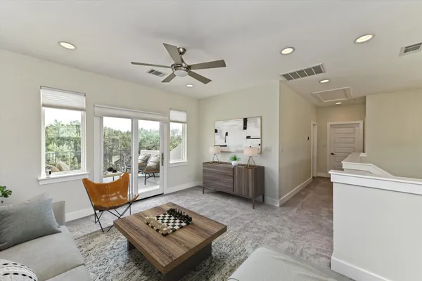 a view of an empty room with a window and a ceiling fan