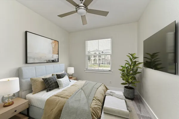 an empty room with a window and a fan