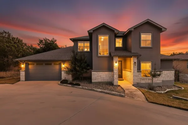 a front view of a house with a yard