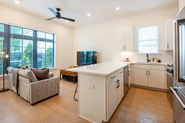 a kitchen with a sink cabinets appliances and a window