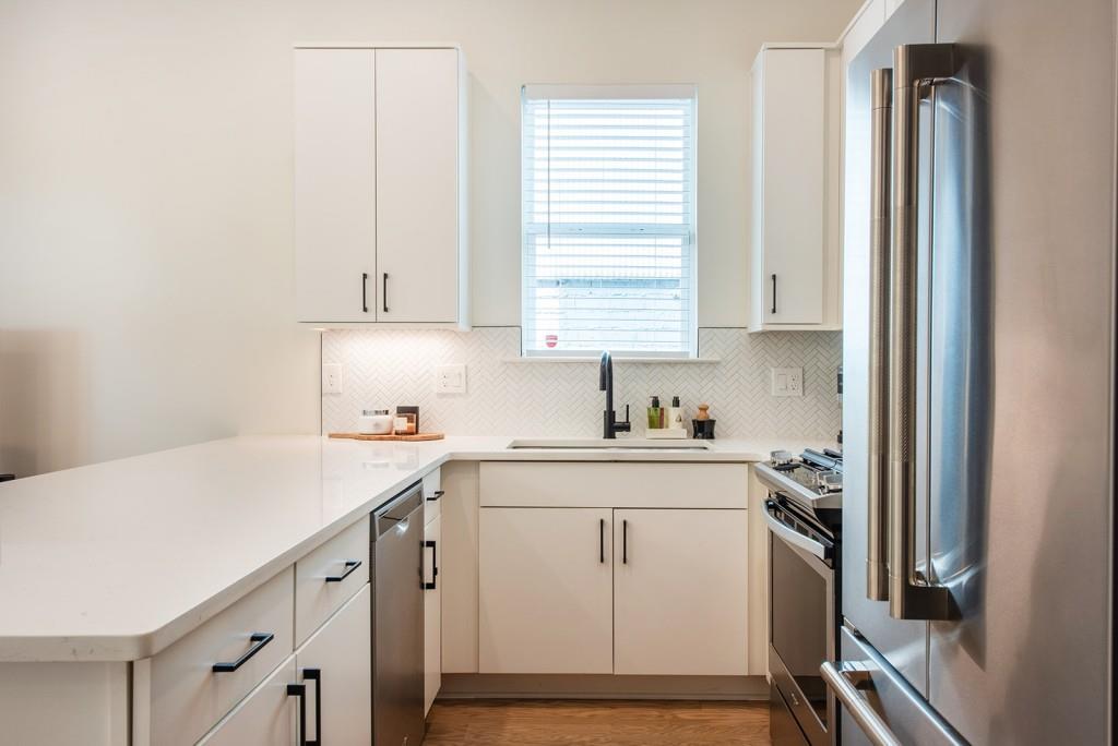 417 East College Avenue, Unit 102 Decatur, GA 30030 - Photo 13 of 60 a kitchen with a sink cabinets appliances and a window