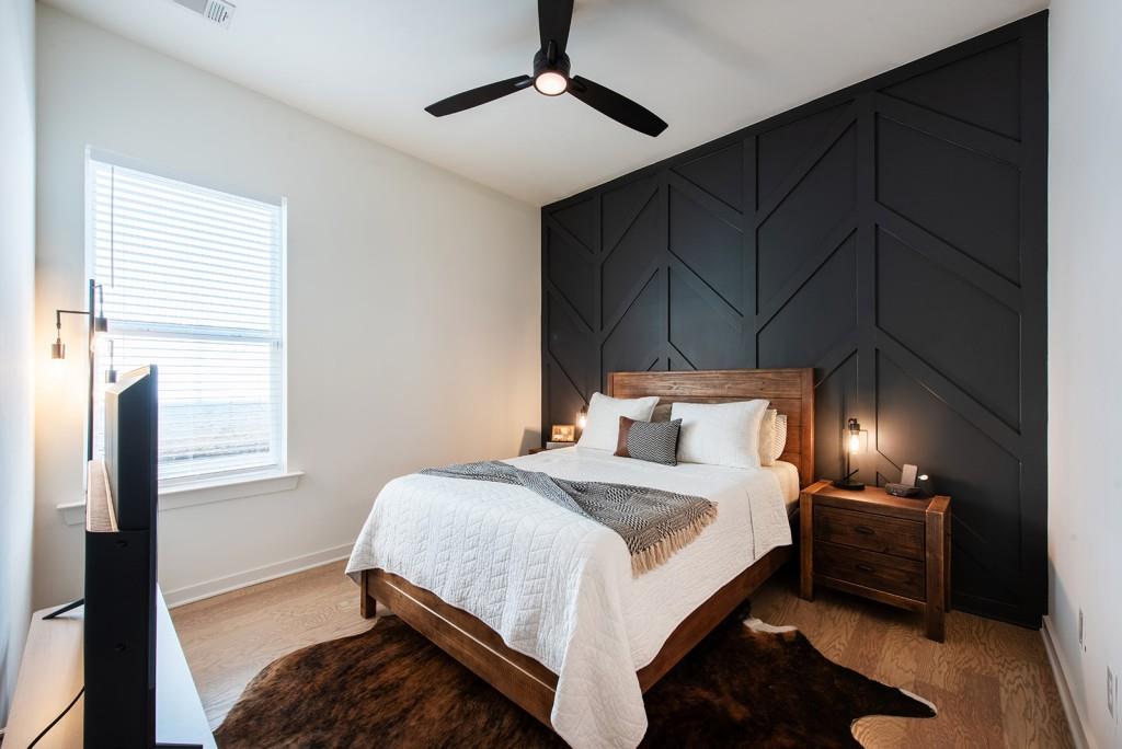 417 East College Avenue, Unit 102 Decatur, GA 30030 - Photo 15 of 60 a bedroom with a bed and a lamp