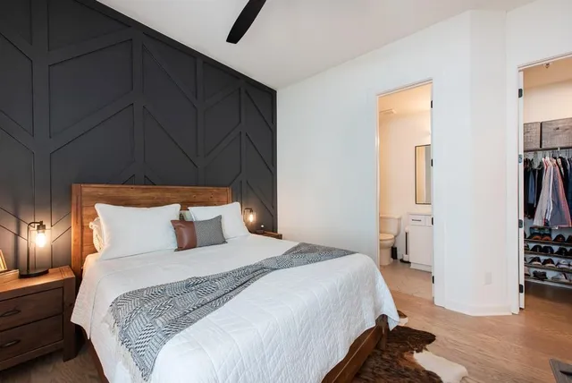 a bedroom with a bed and lamp