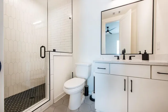 a bathroom with a shower toilet and a sink