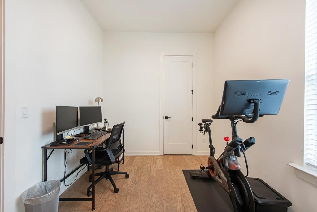 417 East College Avenue, Unit 102 Decatur, GA 30030 - Photo 21 of 60 a view of a workspace with furniture and a gym cycle