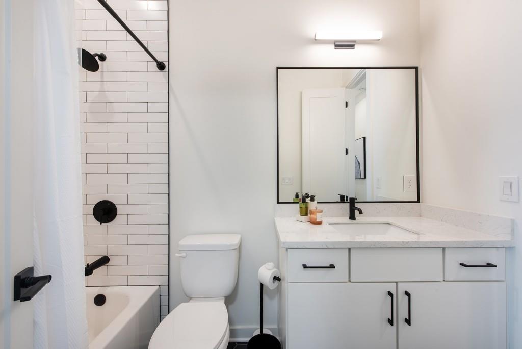 417 East College Avenue, Unit 102 Decatur, GA 30030 - Photo 22 of 60 a bathroom with a sink a toilet and shower