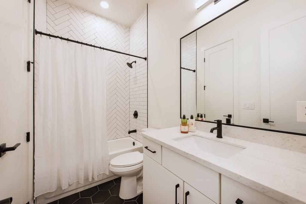 417 East College Avenue, Unit 102 Decatur, GA 30030 - Photo 23 of 60 a bathroom with 2 sink toilet and shower