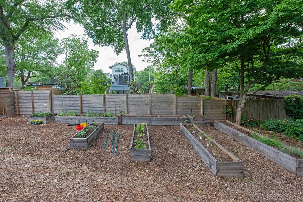 417 East College Avenue, Unit 102 Decatur, GA 30030 - Photo 31 of 60 a wooden bench sitting in the middle of a yard