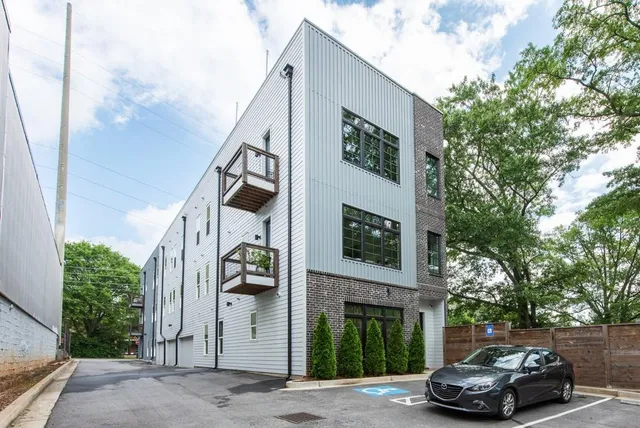 a view of a brick house with a yard and large windows