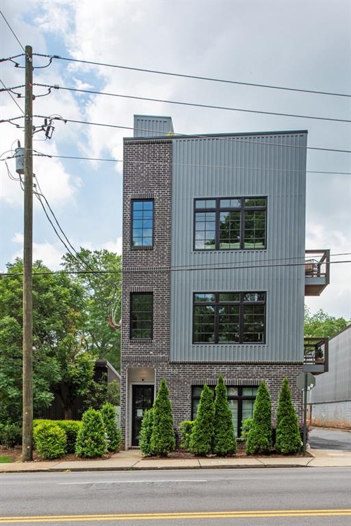 417 East College Avenue, Unit 102 Decatur, GA 30030 - Photo 33 of 60 a view of a brick house with a yard and large windows