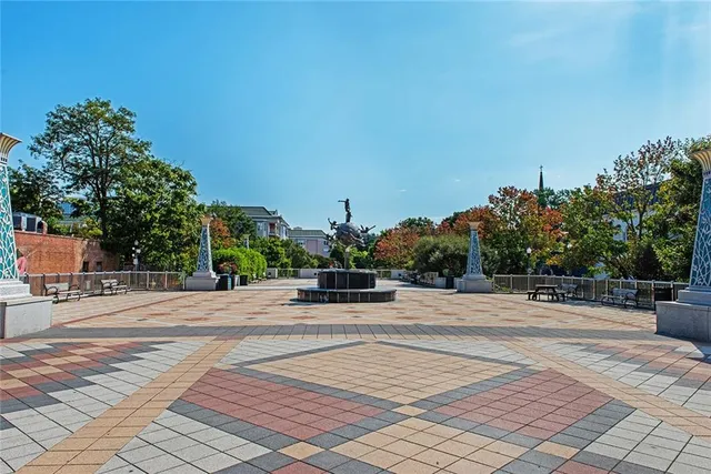 a front view of a multi story building with yard and outdoor seating