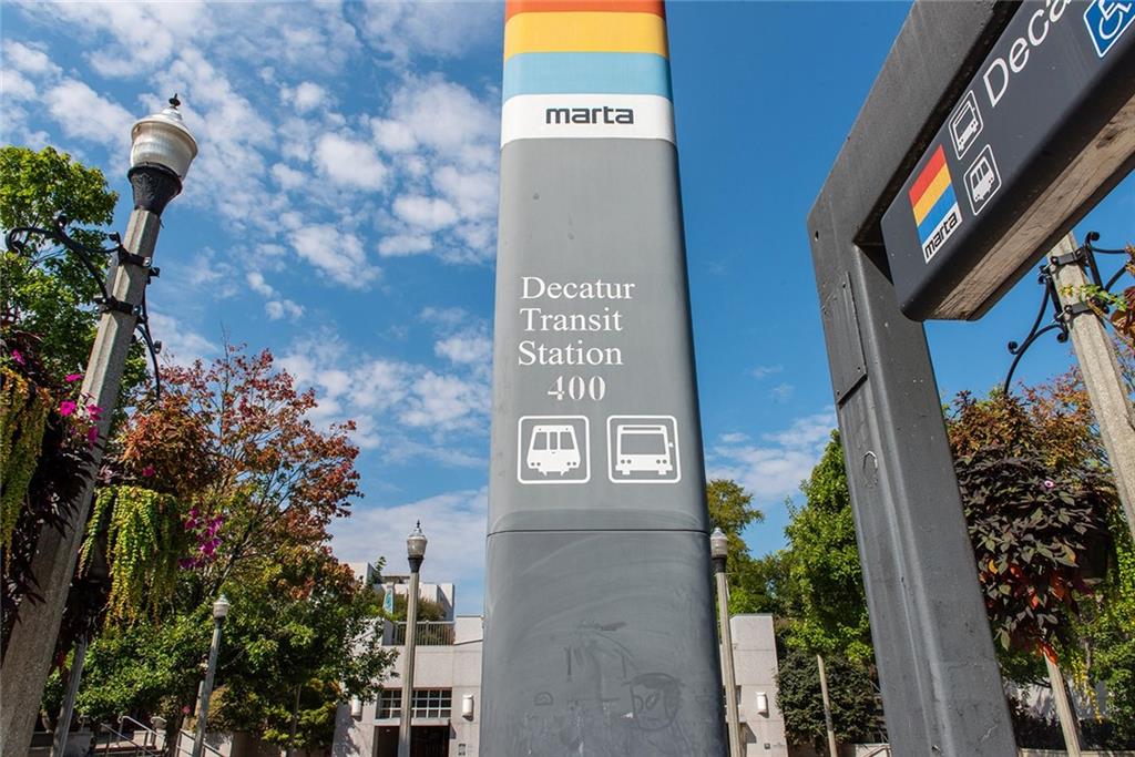 417 East College Avenue, Unit 102 Decatur, GA 30030 - Photo 37 of 60 a sign that is sitting on a brick wall