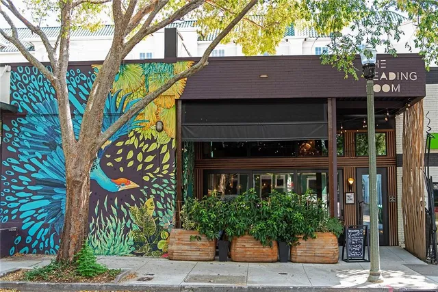 a view of a patio with a table and chairs under an umbrella