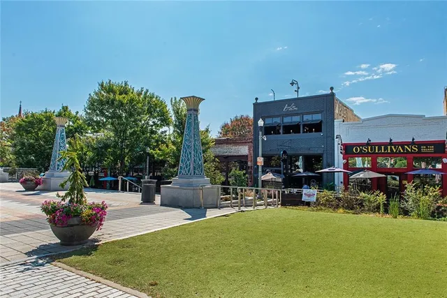a park view with a bench and trees in the background