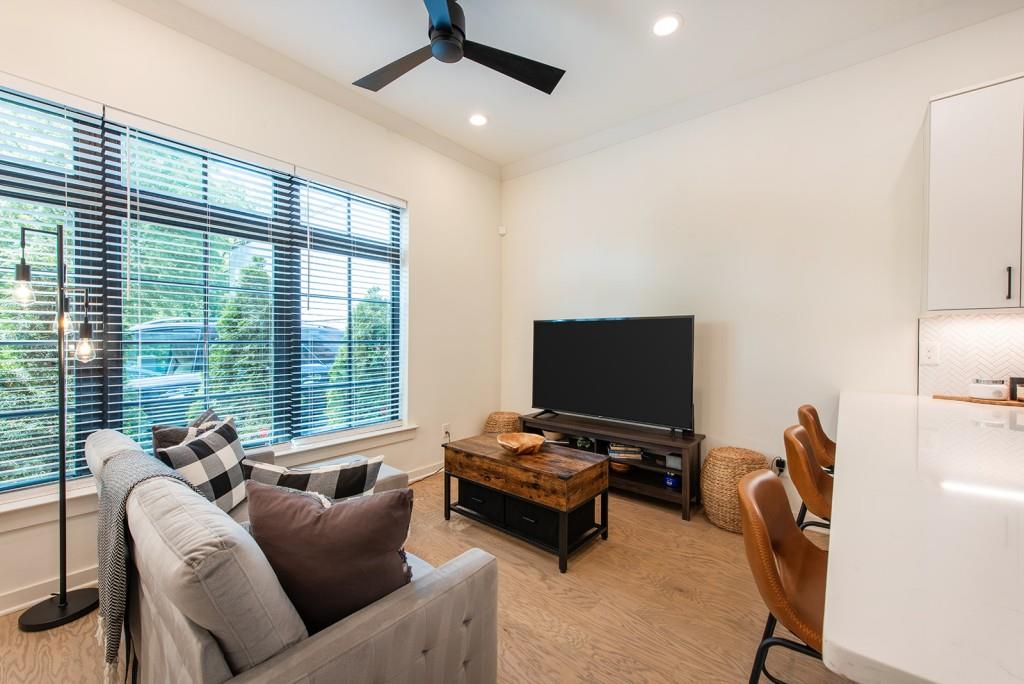 417 East College Avenue, Unit 102 Decatur, GA 30030 - Photo 5 of 60 a living room with furniture a ceiling fan and a window