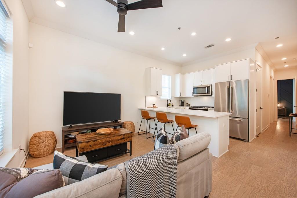 417 East College Avenue, Unit 102 Decatur, GA 30030 - Photo 7 of 60 a living room with furniture and a flat screen tv