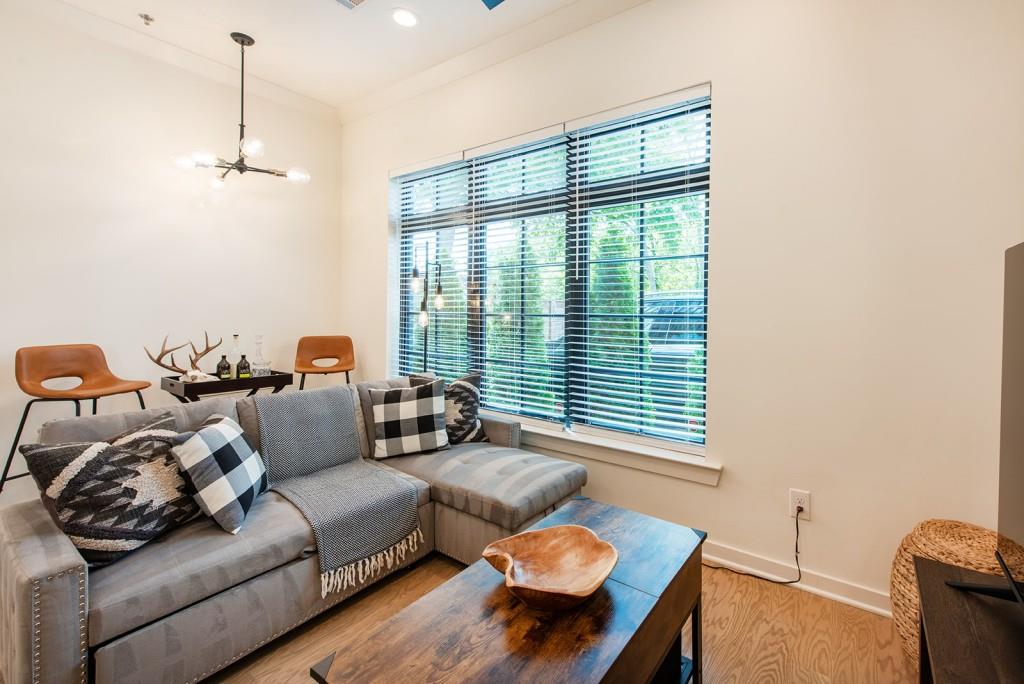 417 East College Avenue, Unit 102 Decatur, GA 30030 - Photo 10 of 60 a living room with furniture and a window