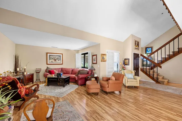 a living room with furniture and wooden floor