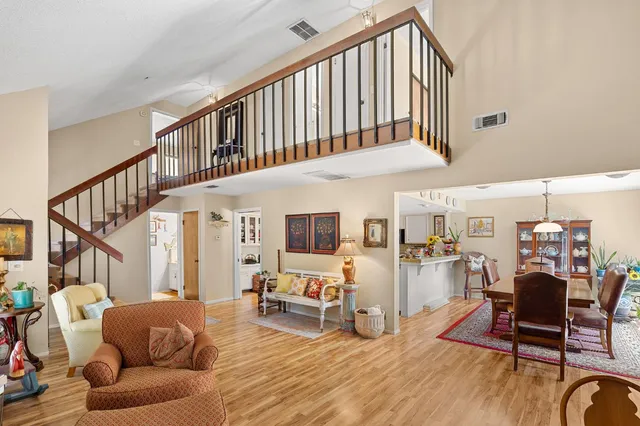 a living room with furniture or wooden floor and a large window