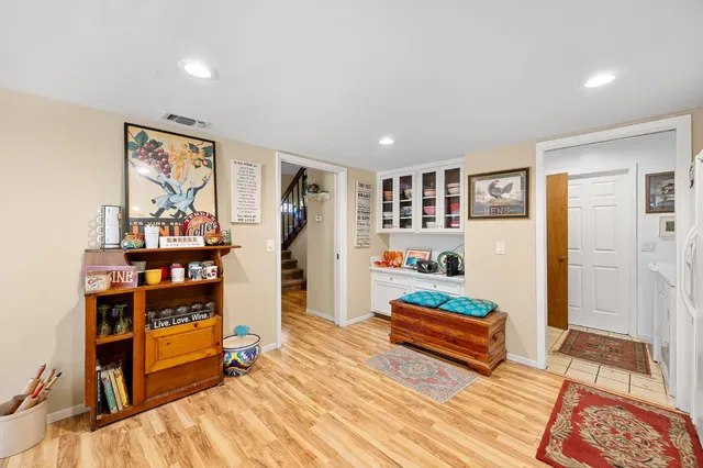 a living room with furniture and a book shelf