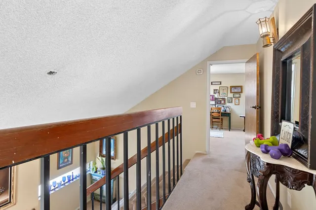 a bedroom with a bed table and chair