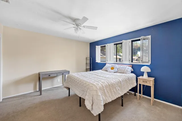 a bedroom with a bed and a window