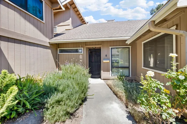 a view of a house with potted plants