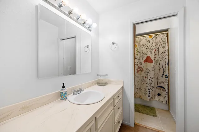 a bedroom with a bed a lamp and a chandelier