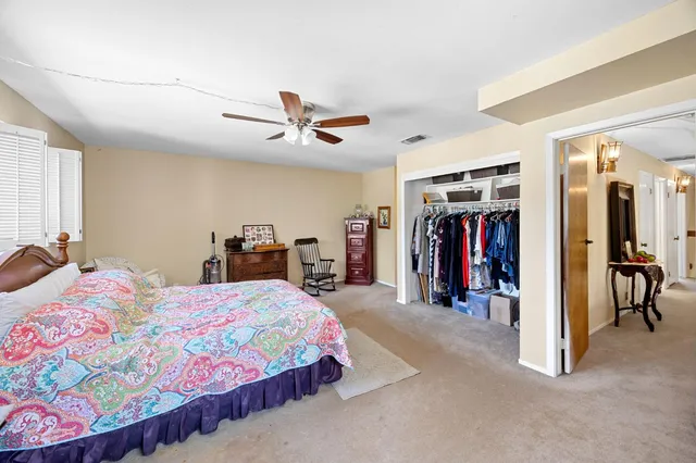 a en suite bathroom with a double vanity sink and a mirror