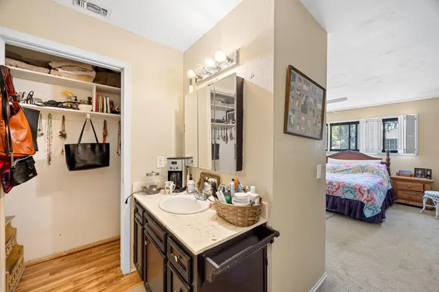 a bathroom with a granite countertop sink and a mirror