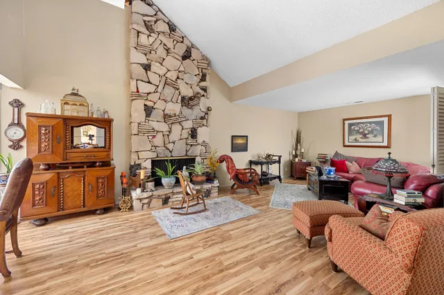 a living room with furniture a fireplace and a flat screen tv