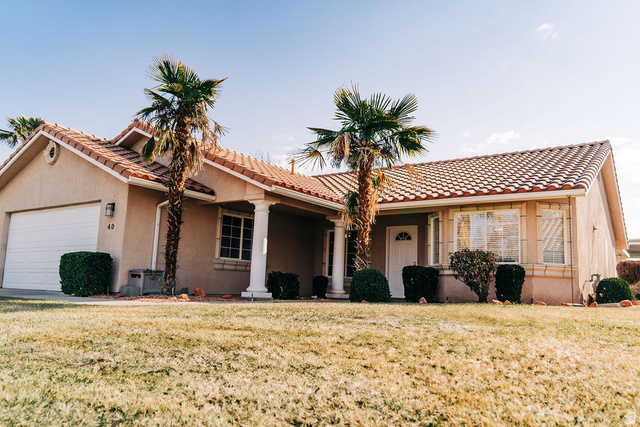 1825 West Mathis Park Place, Unit 40 St. George, UT 84770 - Photo 3 of 28 View of front of property featuring stucco siding, a front yard, a garage, and a tile roof