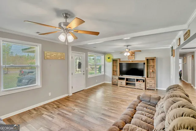 a living room with furniture and a flat screen tv
