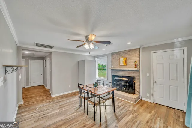 a living room with furniture wooden floor and a fireplace