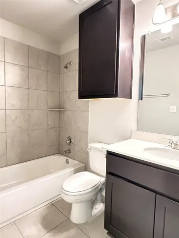 a bathroom with a sink a toilet a mirror and bathtub