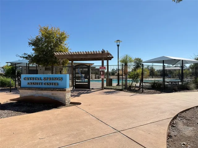 a view of a table and chairs under an umbrella