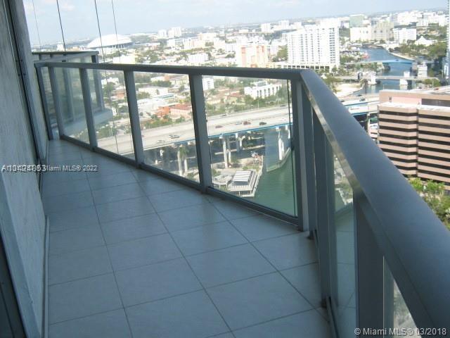 185 Southwest 7th Street, Unit 2207 Miami, FL 33130 - Photo 7 of 8 a view of a balcony with furniture and city view