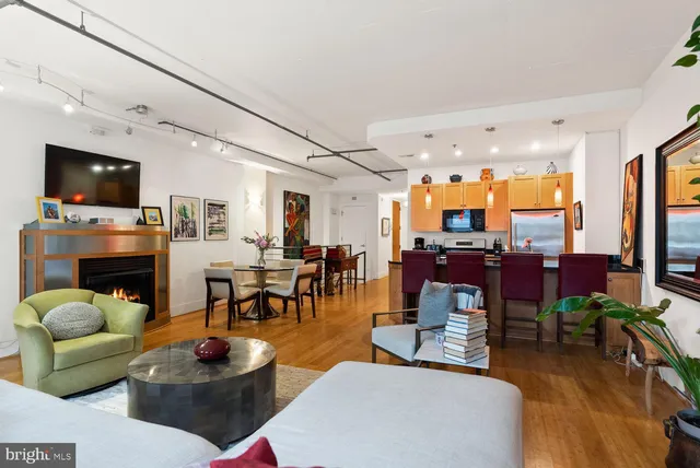 a living room with fireplace furniture and a flat screen tv