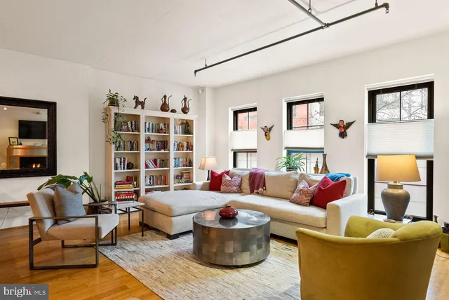 a living room with furniture and a lamp