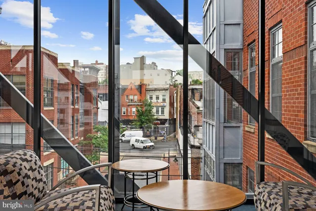 a balcony view with couple of chairs and a stove