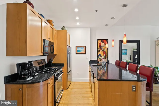 a kitchen with stainless steel appliances granite countertop a stove and a refrigerator