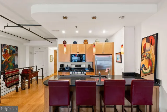 a dining room with furniture a rug and a flat screen tv