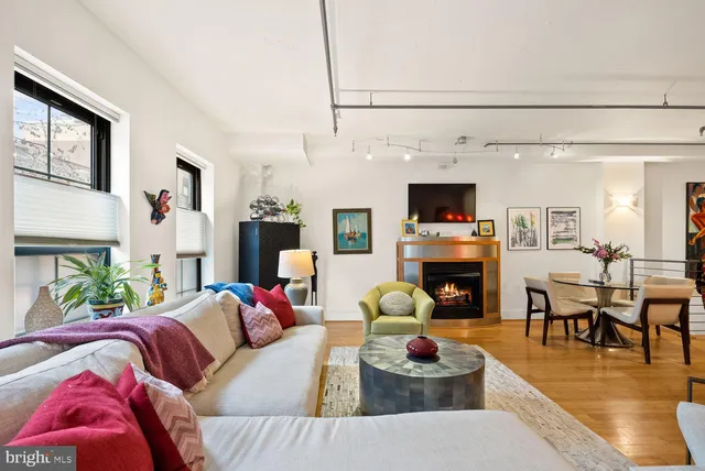 a living room with fireplace furniture and a flat screen tv