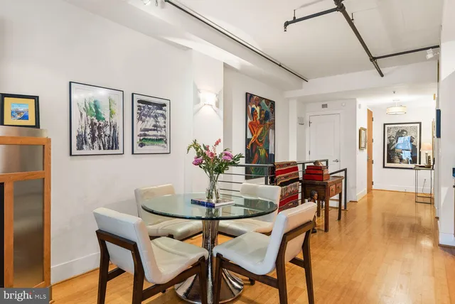 a view of a dining room with furniture and wooden floor