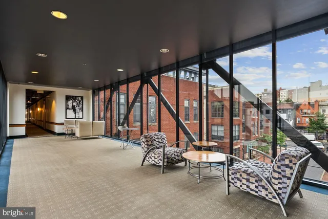 a view of an empty room with large windows