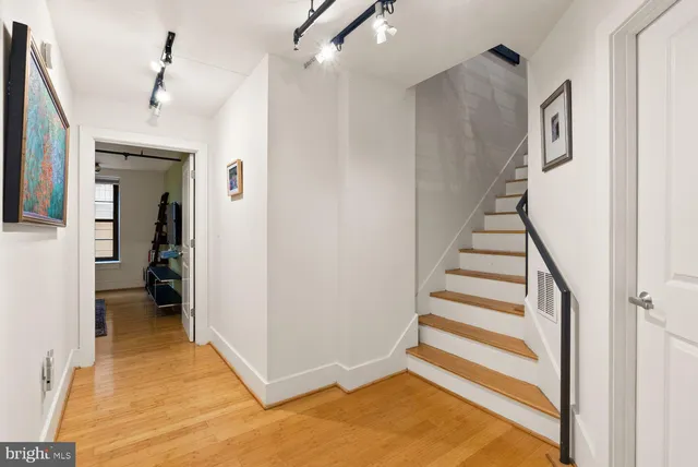 a view of entryway and hall with wooden floor