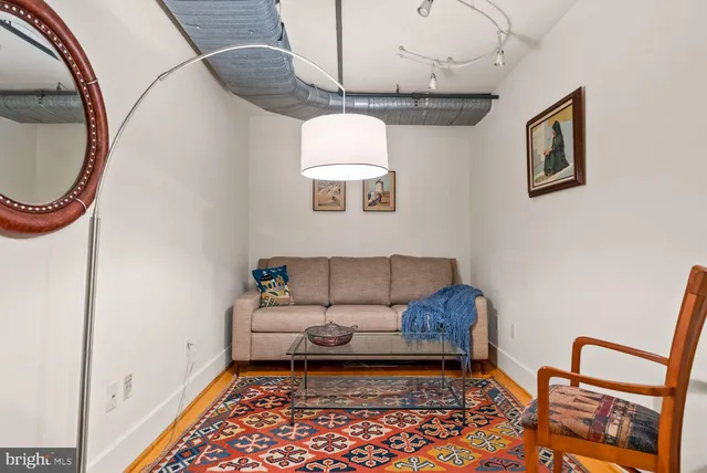 a living room with furniture and a rug