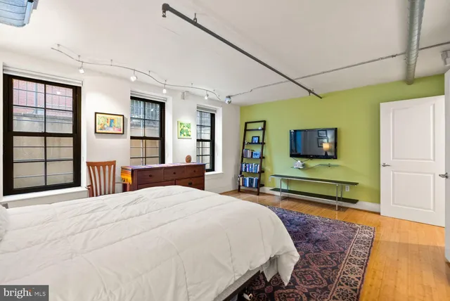 a bedroom with a bed and a flat screen tv