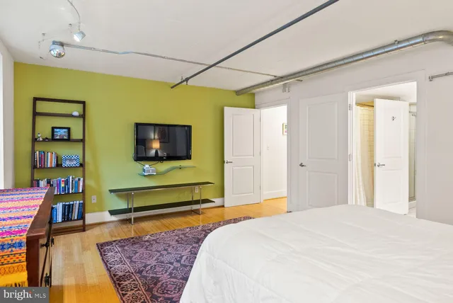 a bedroom with a bed and flat screen tv