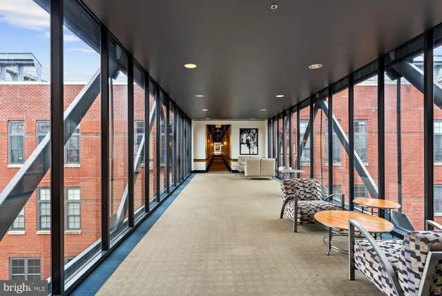 a view of an entryway with couches and floor to ceiling window